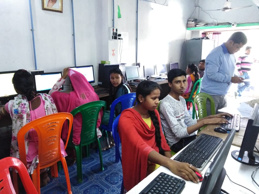 Rural youth and girls learning digital computer skills