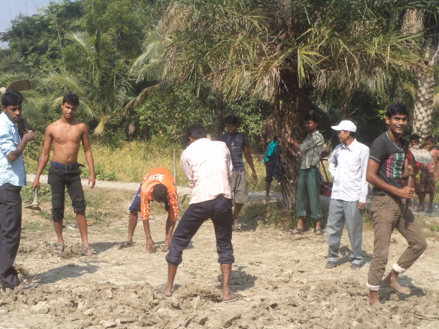 Farmers leveling soil and field preparation