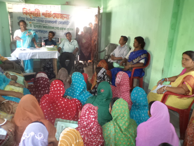 Kishori Shakti Yojana Programme meeting banner and participants