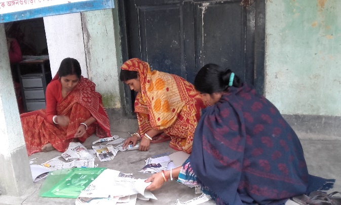 Rural women fabricating eco-friendly paper packets