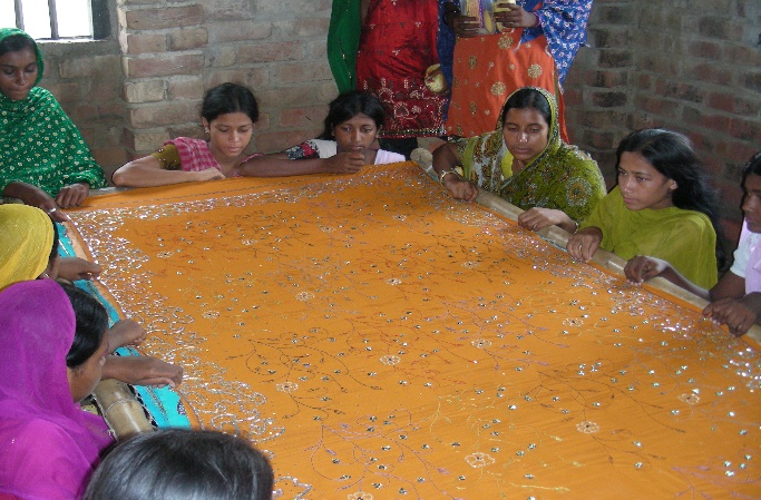 Artisan practicing zari embroidery on stretched fabric